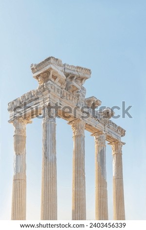 Temple of Apollo in ancient Side (Turkey). Entablature of the ruined temple with stone-cut relief on the frieze. Sunrise, pastel colored sky background. Vertical. History, art or architecture concept