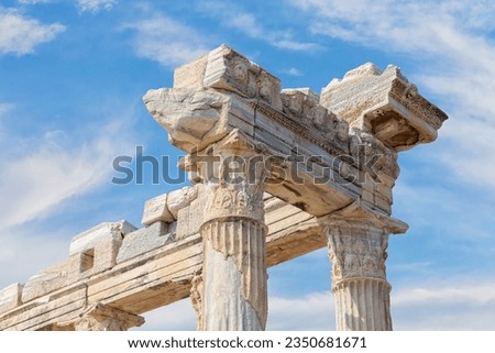 Temple of Apollo in Side (Turkey). Close up fragment of the entablature of the ruined temple. Stone-cut relief on the frieze. Scenic clouds as background. History, art or architecture concept