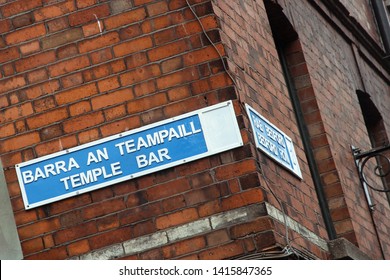 temple bar street sign on red brick wall in dublin as symbol for drinking, beer and irish pubs