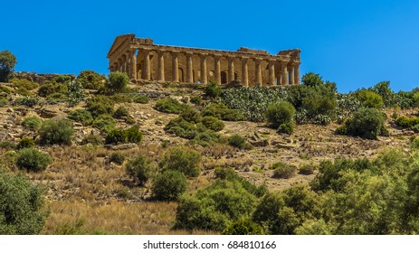 The Temple Of Concordia On The Summit Of A Ridge Above The Plain Around The Sicilian City Of Agrigento, In Summer 