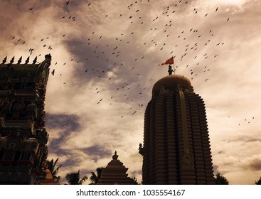 Temple with flying pigeons 