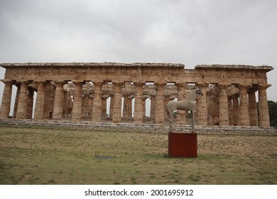 Temple Of Hera Behind A Sand Horse Statue At Paestum, Campania, Italy