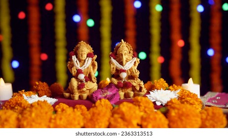 Temple of Indian gods Laxmi and Ganesh for Diwali - the festival of lights. Pan shot of the Lord Ganesha and Goddess Laxmi with a decorated festive background - Diwali - the festival of India