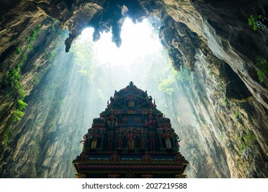 A temple inside a cave with ray of light down from the top