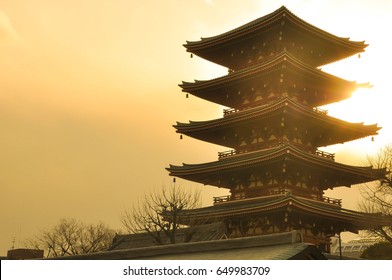 Temple Of Japan With Gold Light Sky Background.