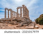 The Temple of Poseidon, ancient ruined Greek marble temple, on the mountain top under blue sky