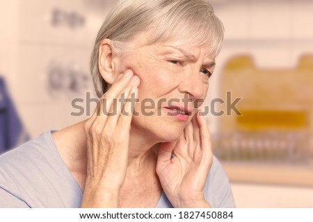 Temporal arteritis: senior woman suffering from painful jaw joints, filter effect. Foto stock © 