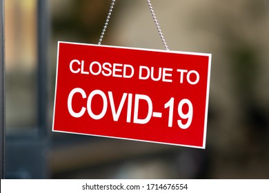 Temporarily closed sign for Covid-19 in small business activity. Information notice sign about quarantine measures. Close up on a red closed placard in the window of a shop for coronavirus. - Shutterstock ID 1714676554