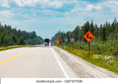 Temporary Condition Road Warning Signs On Roadside Before Road Work Zones, Diversions, Detours, Lane Closures Or Traffic Control People On The Road