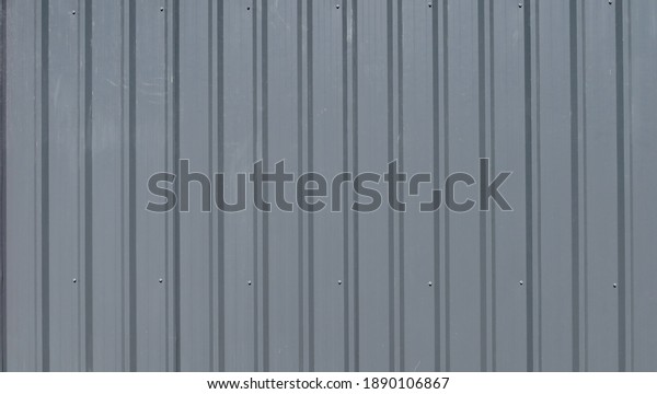 Temporary\
corrugated gray wall partition with\
rivets