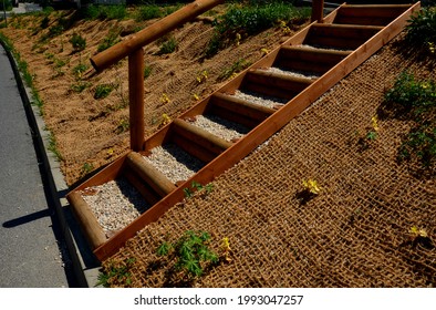 Temporary Covering Of The Lawn Sowing With Textiles To Ensure A Large Slope Against Erosion. Using Brown Jute Fabric Stabilizing Coconut Net For Steep Slopes. In Heavy Rain The Soil Does Not Leach Out