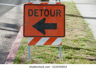Temporary DETOUR sign with an arrow pointing to the left