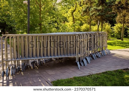 Temporary fencing. Security. Mass event. A large crowd of people. Portable sectional fence. Steel mobile fence on the street. Police fence.