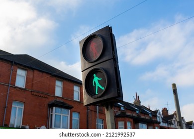 Temporary Pedestrian Crossing Lights With The Green Man Symbol Illuminated For Go