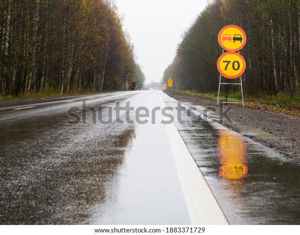 temporary road signs on the road with speed limit.
repair of roads