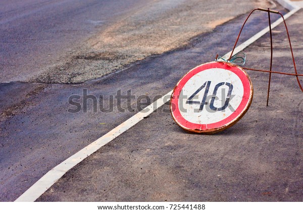 Temporary speed limit sign is\
installed on asphalt at the site of road construction\
works\
