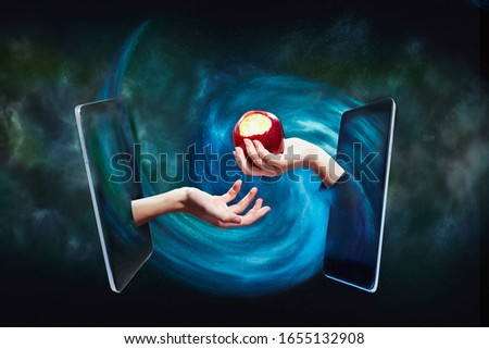 The temptation of knowledge, Internet access. Hand with an apple in a smartphone