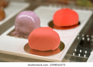 A tempting array of heartshaped desserts presented in vibrant, eyecatching colors such as red and purple.