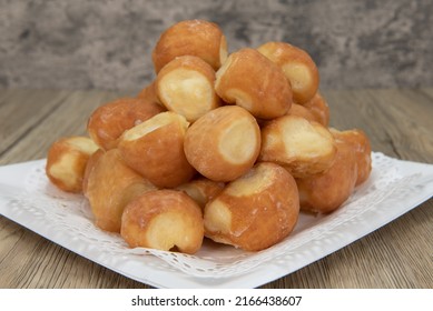 Tempting Fresh From The Oven Glazed Donut Holes From The Bakery Stacked On A Plate.