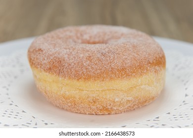 Tempting Fresh From The Oven Sugar Glazed Donut From The Bakery Served On A Plate.