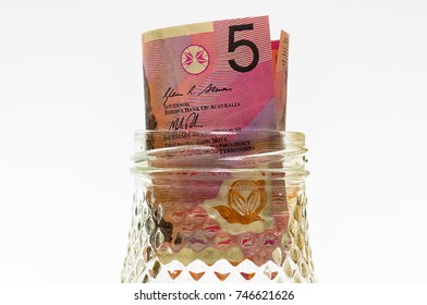 Ten Australia Dollar Inside Glass Jar Isolated On White.financial Concept