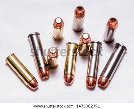 Ten bullets, five .38 special full metal jacket and fice .357 magnum ones on a white background