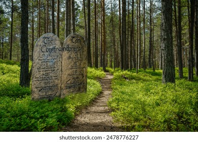 Ten Commandments at start of path in forest 