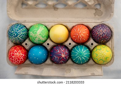 ten hand painted colorful easter eggs in an egg carton