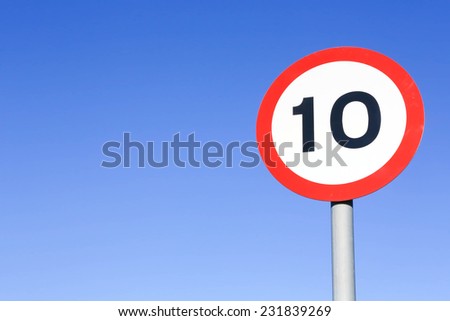 Ten miles per hour speed limit sign against a clear blue sky.