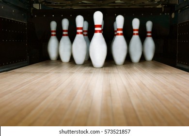 Ten pin bowling alley background. Closeup of tenpin row on a lane, night light.