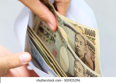 Ten Thousand, One Thousand And Five Thousand Yen Japanese Money In White Envelope And Business Woman Hand Japanese Yen Bills In Envelope