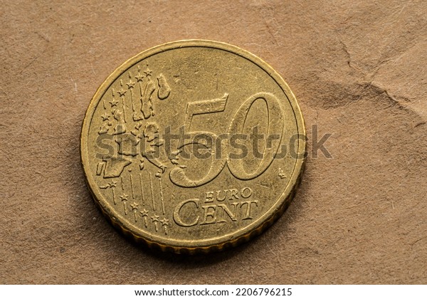 Ten, Twenty, Fifty euro cent lying on the rough paper\
background. 