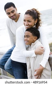 Ten Year Old African-American Boy With Parents At Beach