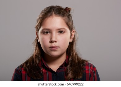 Ten year old girl looking to camera, head and shoulders