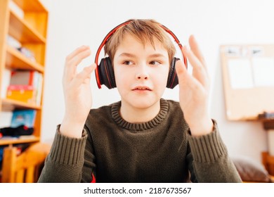 Ten Year Old School Boy Talking With Head Set In Home Video Schooling Situation, Close Up Looking Into Wide Angle Camera