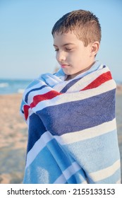 Ten Years Old Kid Wrapped In A Blue Towel After Having A Bath At The Beach. Mediterranean Summertime Lifestyle Concept.