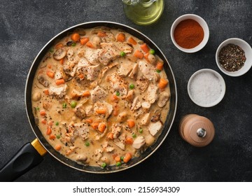Tender chicken fillet in a creamy mushroom sauce with rice and green peas. Chicken stew with vegetables and mushroom cream sauce.  - Shutterstock ID 2156934309