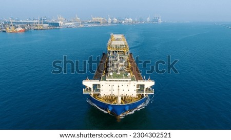 Tender Drilling Oil Rig on Barge Ship transportation Rid to Oil Rig in The Middle of The Ocean at Sunset. Barge Ship transport Big equipment of oil rid.