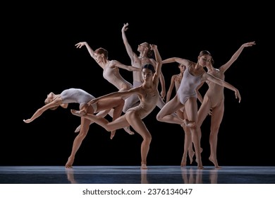 Tender, elegant young people, ballet dancers making beautiful performance on stage against black background. Concept of classical and modern dance, beauty, creativity, art, theater - Powered by Shutterstock