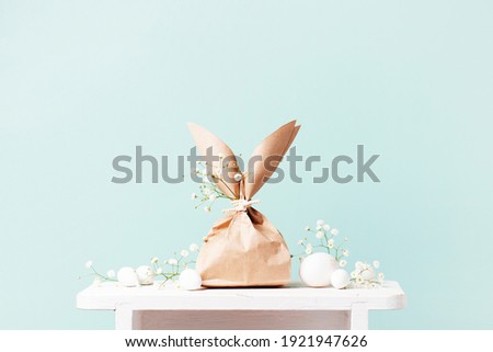 Tender festive Easter card with gifts and eggs decorated with flowers