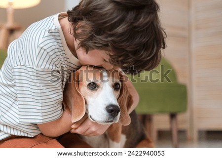 tender hug from a child to his beagle, an image that captures the affectionate bond and trust between a young owner and his devoted pet. boy embrace around his dog exudes warmth and care,
