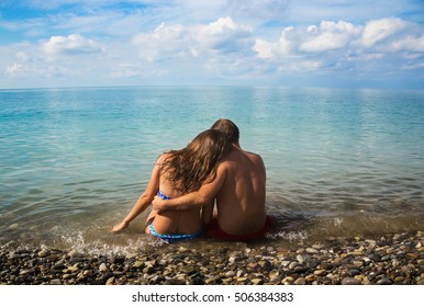 Tender loving couple sitting on the beach