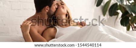 Similar – Beautiful woman looking to man lying on bed