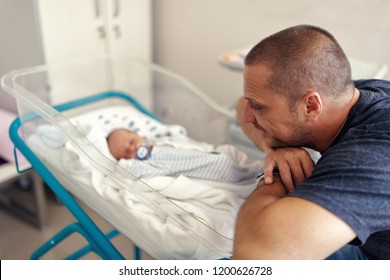 Tender Moment Between A Father And His Newborn Baby Boy