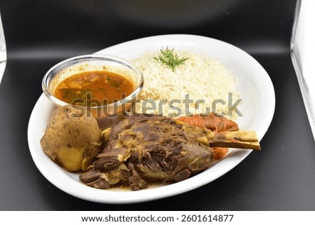 Tender Mutton Leg Served with Aromatic Rice and Spiced Gravy