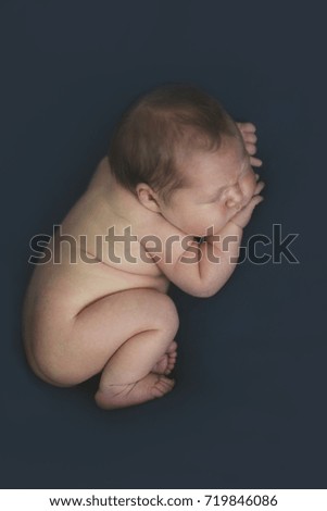 Similar – Baby yawning lying on a carpet