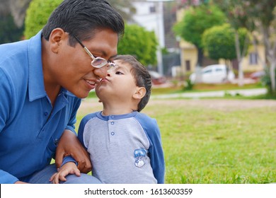 Tender Portrait Of Native American Man With His Little Son In The Park.