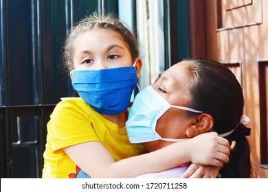 Tender Portrait Of Native American Mom With Her Little Daughter. Both Wearing Masks.