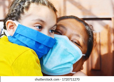 Tender Portrait Of Native American Mom With Her Little Daughter. Both Wearing Masks.