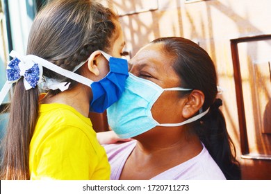 Tender Portrait Of Native American Mom With Her Little Daughter. Both Wearing Masks.